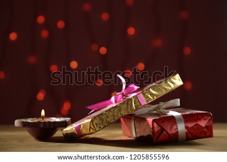 Diwali gift, Festive Gifting on an illuminous background , festive greeting Royalty-Free Stock Photo #1205855596