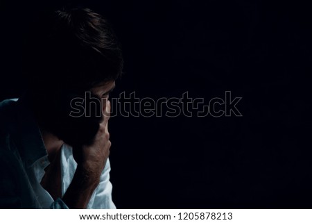 Portrait of handsome man with problems, copy space on the black background