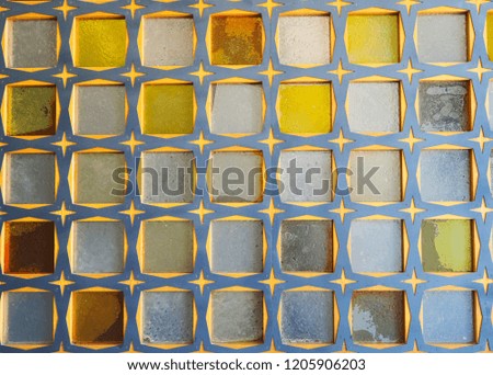 Glass block wall of blue-yellow colors. Oriental pattern, texture and background concept