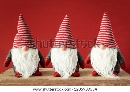 An image of three Christmas gnomes with white beards