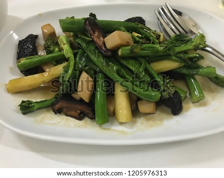 Delicious fried vegetables, mushroom, morning glory, kale with fork and spoon, healthy food, green asian dish, Chinese cooking, stock photo image