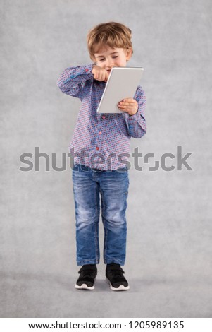 happy young businessman is pushing something on the tablet