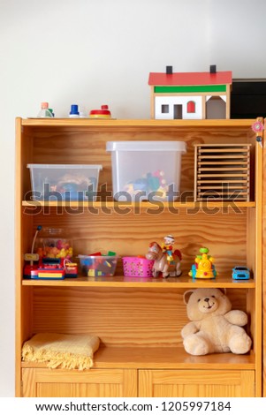 Several playtime toys on a wooden shelf.