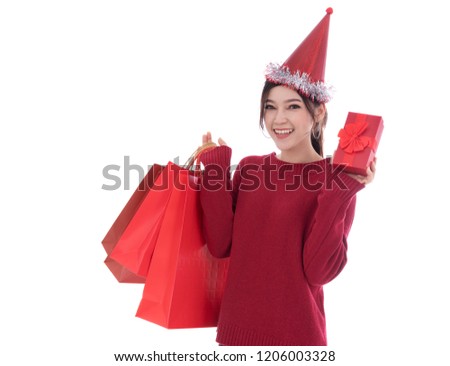 cheerful woman holding Christmas gift box and shopping bag isolated on a white background