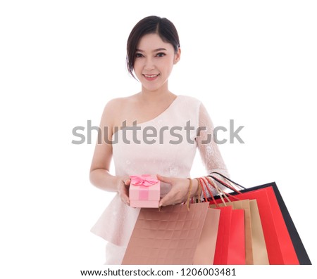 young happy woman holding gift box and shopping bag isolated on a white background