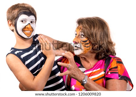 Child and grandmother with animal face-paint isolated in white