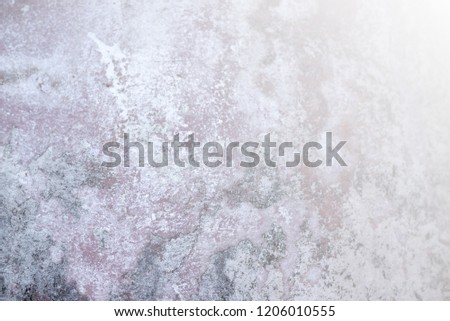 Gray cement surface with light for background.