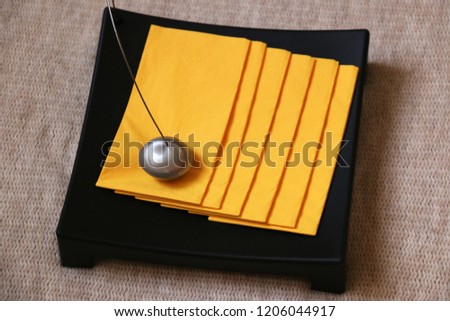 Decorative table napkin holder with yellow napkins Royalty-Free Stock Photo #1206044917