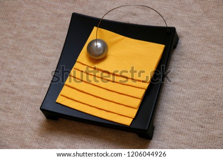 Decorative table napkin holder with yellow napkins Royalty-Free Stock Photo #1206044926