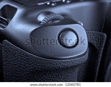 Macro of shutter release button on photo camera - technology background