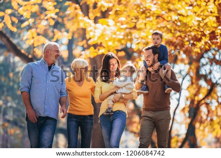 Multl generation family in autumn park having fun Royalty-Free Stock Photo #1206084742