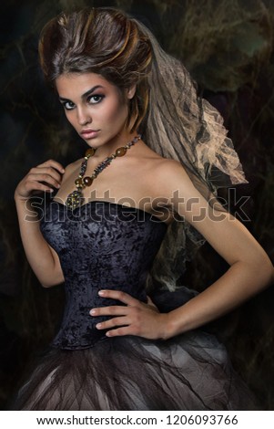 girl in black dress. studio close up portrait of young beautiful girl with hairstyle