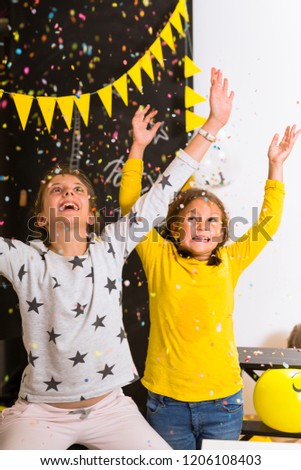 Kids having fun with confetti on birthday party