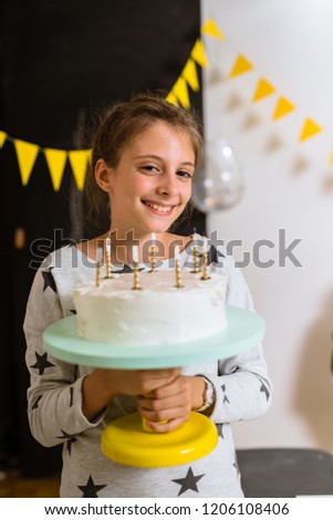 Girl holding birthday cake