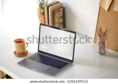 Workspace of creative designer with blank screen laptop.