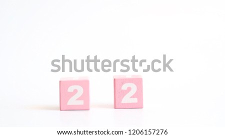 Number 22, twenty two, Pink wooden cube with number isolated on white background with copy space for text or word.