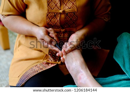 Thailand foot massage by stick wood, spa foot treatment,Thailand massage.