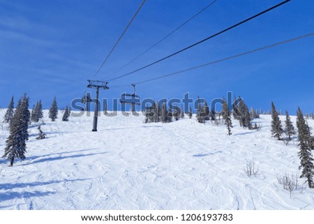 Ropeway on peak at Mount Zelenaya in ski resort Sheregesh. Siberia, Russia.