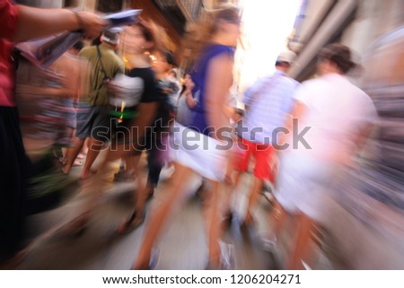 Image slow shutter speed. People walking in motion blur. Long exposure