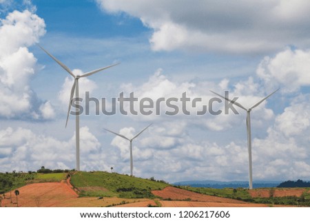 concept idea eco power energy. wind turbine on hill with cloudy