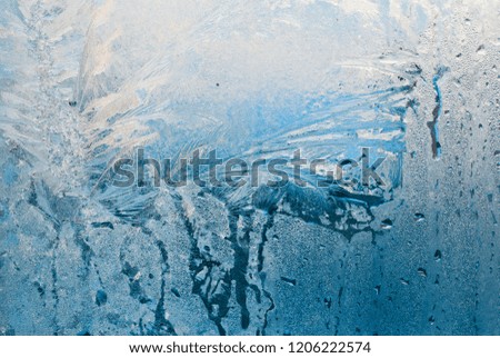 frost work winter background on window glass