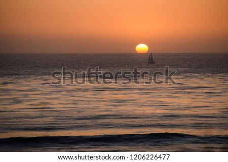 boat on the horizon at sunset