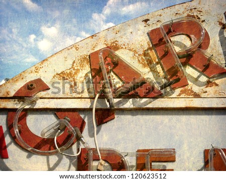   aged and worn vintage photo of neon sign
