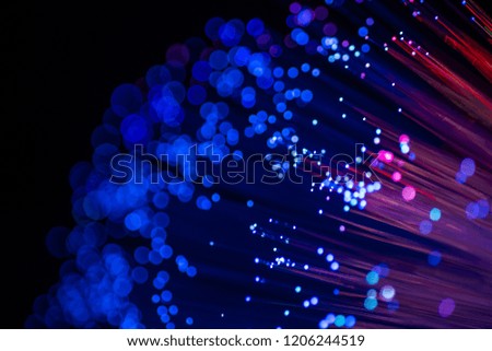 Colorful sparkling light particles. Abstract image. Shooting optical fiber with out focus.