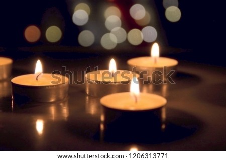 Flame of many candles burning on the bokehs background
