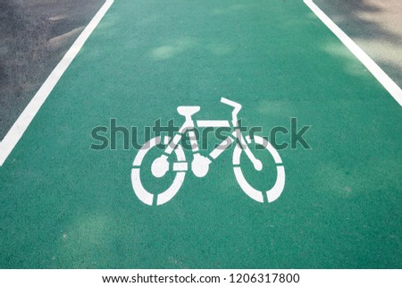 The green lane for bicycle with white bike sign in the park.