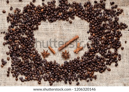 Coffee beans, cinnamon sticks and  anise stars on jute sack. Copy space. Close up.Flat lay.
