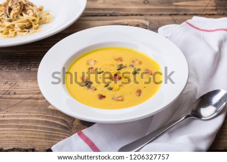 Orange soup with shrimps and herbs