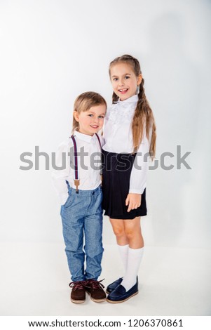 Little cute boy and girl hugging playing on white background, lifestyle people concept.