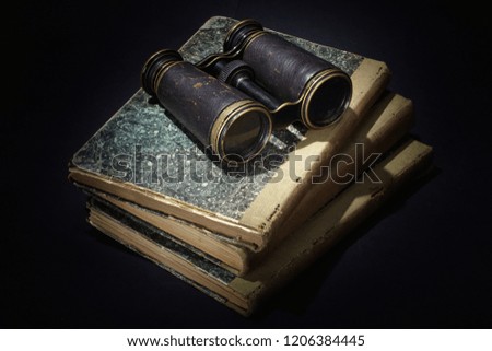 vintage concept - old books, papers, ink pen and inkpot on black background