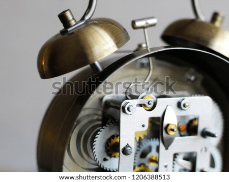 Golden alarm clock with mechanism, gears and details so close