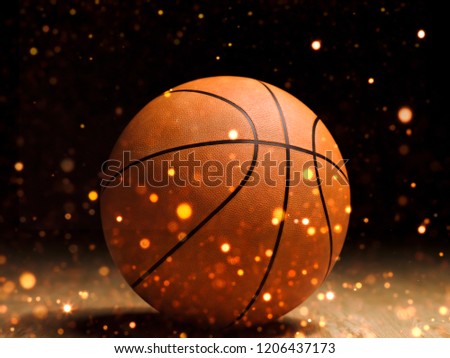 Basketball close-up on black background with bokeh, spotlights