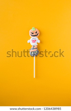 Halloween candies on an colored background