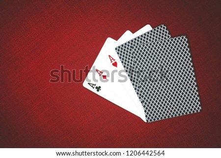 Casino gambling poker equipment and entertainment concept - close up of playing cards and chips at red background. Three of a Kind Royalty-Free Stock Photo #1206442564
