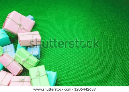 Bright boxes with gifts on a green background close-up