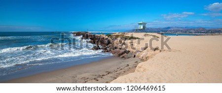 Lifeguard tower and rock jetty seawall in Ventura California United States