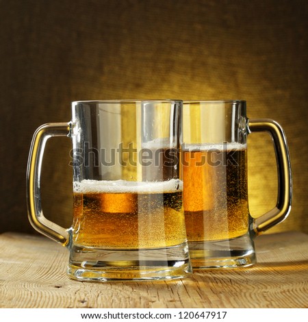 Two beer mugs on wooden table