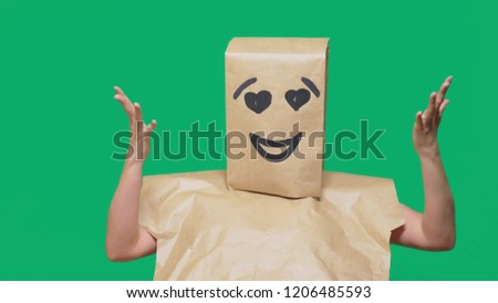 concept of emotions, gestures. a man with paper bags on his head, with a painted emoticon, smile, joy, love eyes.