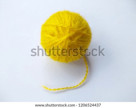 Background of wool yarn, knitted yarn, can also be used as a yarn frame. Yellow knitting yarn for handicrafts isolated on white background.