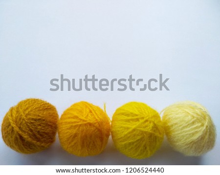 Background of wool yarn, knitted yarn, can also be used as a yarn frame. Yellow knitting yarn for handicrafts isolated on white background.