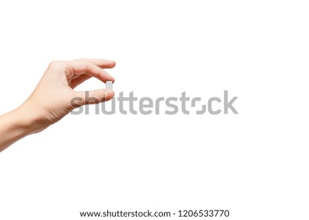 Female hand holding staples. Concept. White background, isolated, close up 