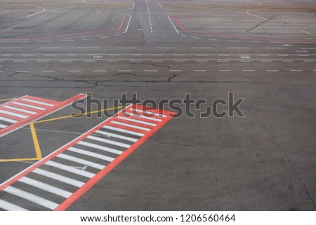 Airport road marking with passenger zebra crossing
