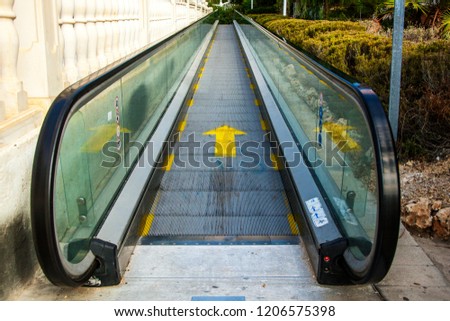 Street escalator. Travolator on the street. Upward movement. City infrastructure.