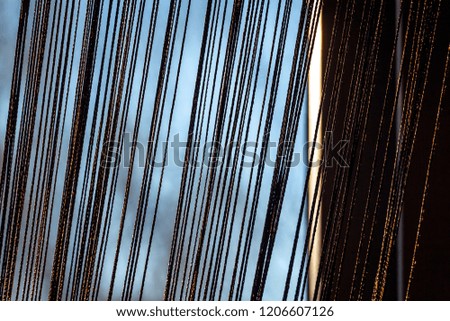 Thin brown rope curtains on the background on the background of evening colors.