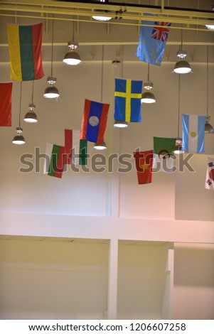 International flags hanging from ceiling of a sport hall. Celebrating the united of different countries, culture and language but togetherness with the same spirit and soul.