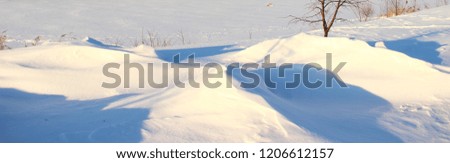 Winter, snow - beautiful landcsape snowdrifts on the endless field, north day panorama view